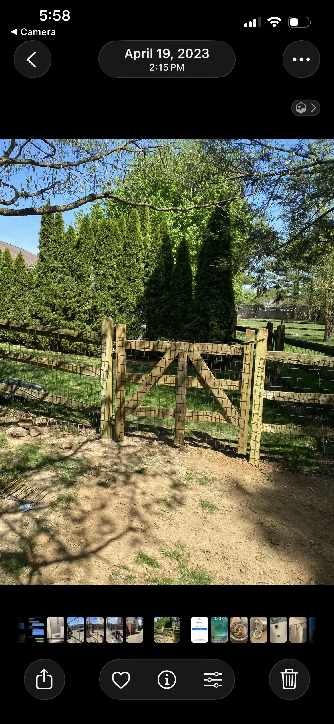 Wooden farm gate with wire mesh infill installed between pressure-treated posts
