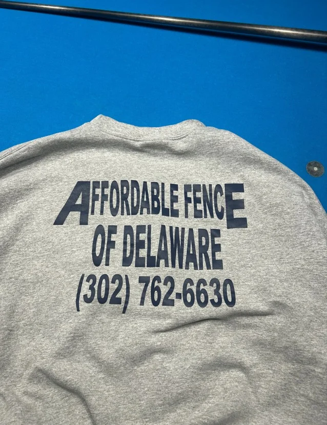 Gray t-shirt with navy screen-printed business name and phone number